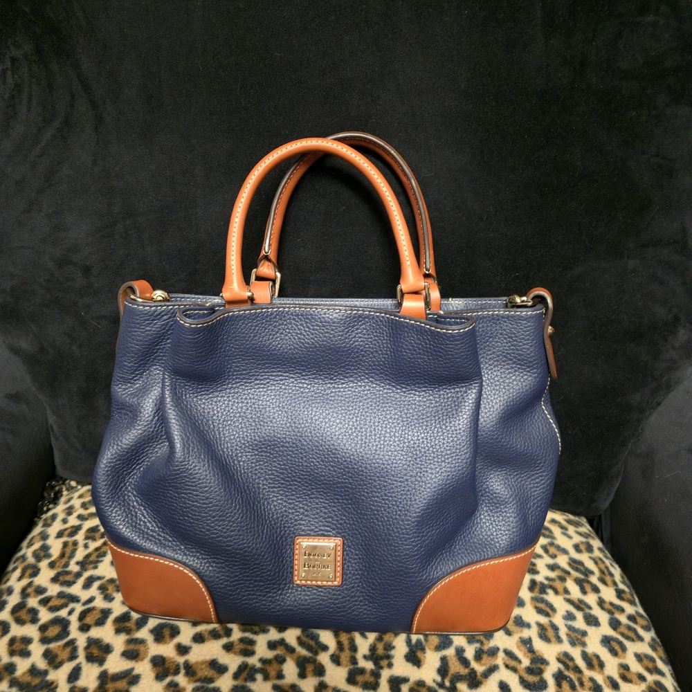 New without tags large Dooney and Bourke Dark Blue with brown trim bag.